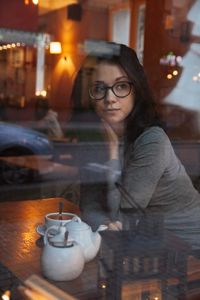 Portrait of woman in illuminated city at night