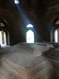 Sunlight streaming through arch window of historic building