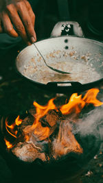 Close-up of hand holding burning leaf