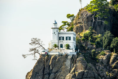 House with lighthouse over the cliff of the ligurian coast, genoa, italy