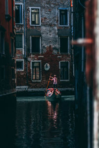 Rear view of man on boat in canal