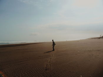 Full length of man on beach against sky