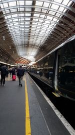 People waiting at railroad station platform