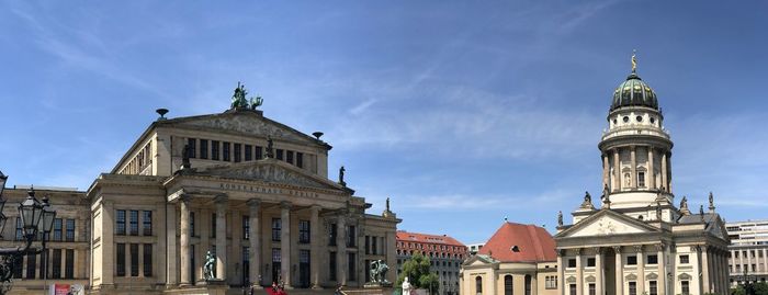 Panoramic view of franzosischer dom and konzerthaus berlin against blue sky