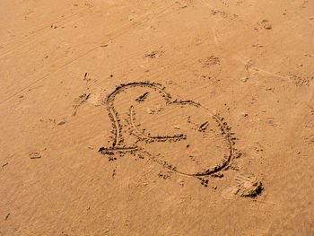 High angle view of text on sand at beach