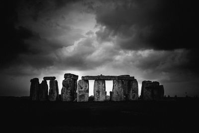 Low angle view of old ruin against cloudy sky