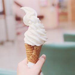 Cropped hand holding ice cream cone