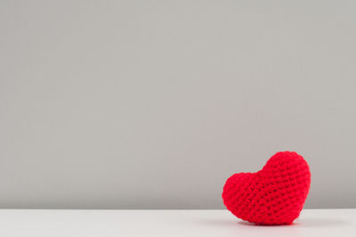 Close-up of red heart shape against white background