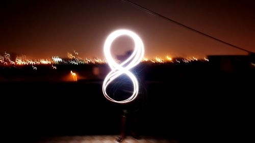 Light painting against sky at night