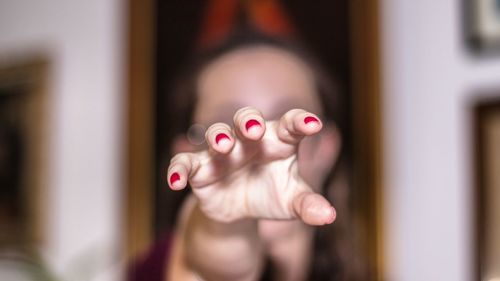 Close-up of woman hand with pink hair