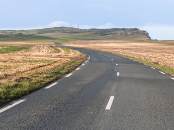 Empty road leading towards mountains