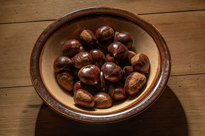 High angle view of roasted coffee beans in bowl on table