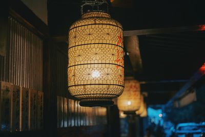 Low angle view of illuminated lanterns hanging in building