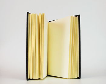 Close-up of books on table against white background