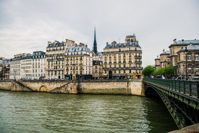 Bridge over river with buildings in background