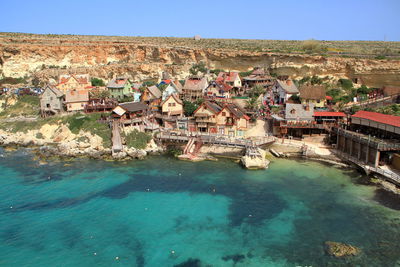 High angle view of buildings in town against sky