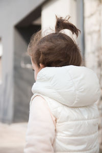 Rear view of girl standing outdoors