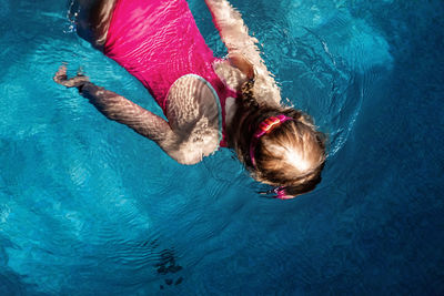 High angle view of woman swimming in pool