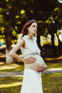 Young woman standing against blurred background