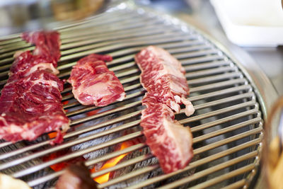 High angle view of meat on barbeque grill