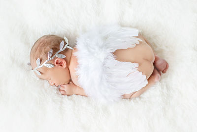 Cute baby sleeping on bed at home