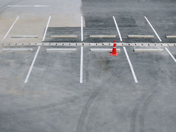 Orange plastic traffic cone at vacant parking lot