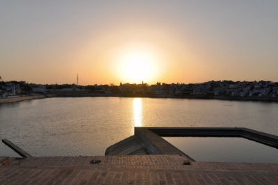 Scenic view of sea against clear sky during sunset