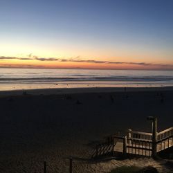 Scenic view of beach against sky during sunset