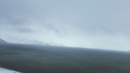 Scenic view of landscape against sky during winter