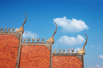 Low angle view of building roof against sky