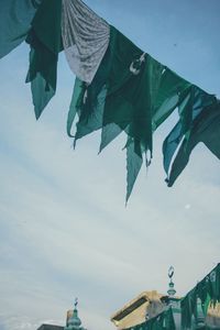 Low angle view of flags hanging against sky