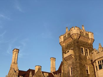 Low angle view of historic building against blue sky