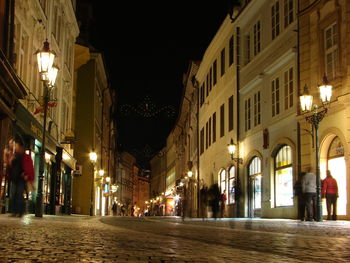 Illuminated street at night in city