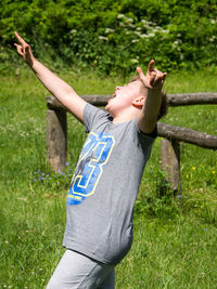 Happy boy standing in grass