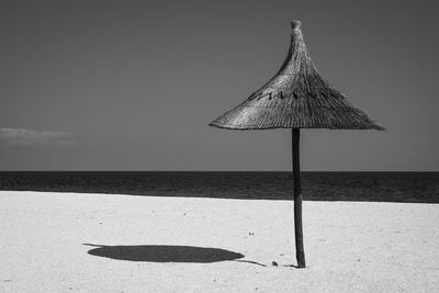 Umbrella on beach against sky