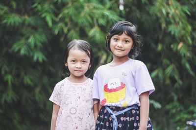 Portrait of cute girl standing outdoors