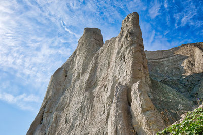 Low angle view of rock formation against sky