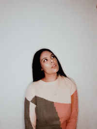 Portrait of a smiling young woman against white background