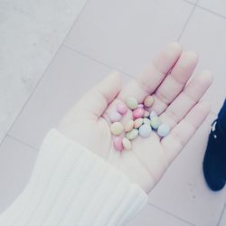 Close-up high angle view of hand holding multi colored candies