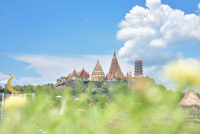 Panoramic view of temple amidst buildings against sky