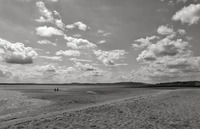 View of beach against cloudy sky