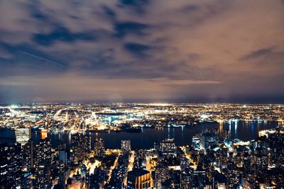 High angle view of illuminated cityscape against sky at night