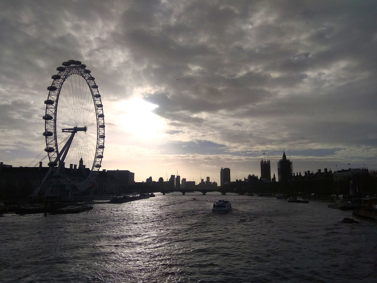 ferris wheel, cloud - sky, sky, river, travel destinations, waterfront, sunset, big wheel, water, building exterior, architecture, built structure, outdoors, city, no people, skyscraper, day, urban skyline, cityscape