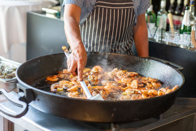 Midsection of man preparing food