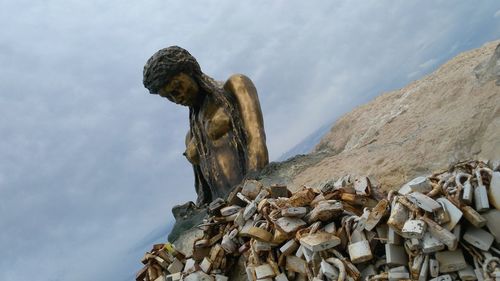 Low angle view of statue against sky