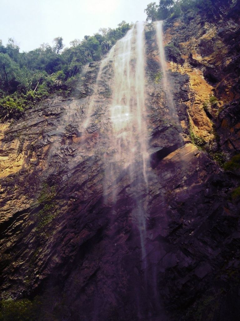 tree, motion, forest, nature, sunlight, waterfall, rock - object, beauty in nature, scenics, sunbeam, road, long exposure, transportation, non-urban scene, tranquility, tranquil scene, the way forward, blurred motion, outdoors, day