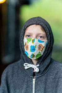 Tween wearing homemade face mask during covid-19 pandemic with hoodie