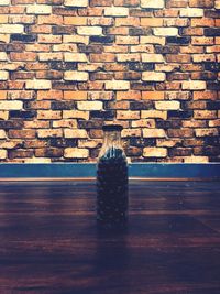 Close-up of stack on table against wall