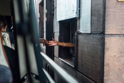 Man standing by train window at railroad station