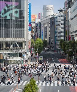 Group of people crossing road in city